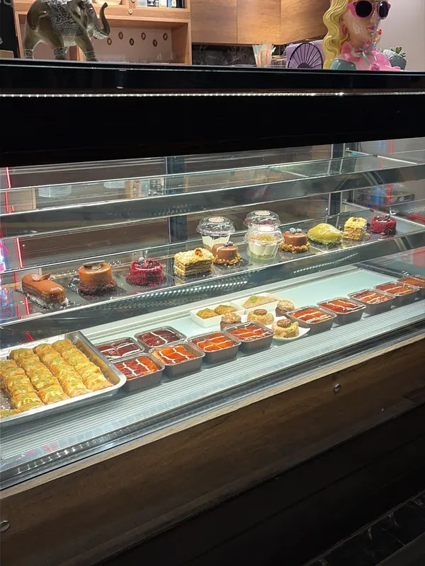 The glass dessert counter with baklava, tres leches and cakes