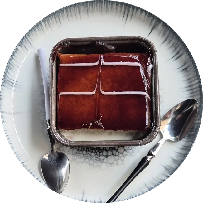 Tres leches cake on a blue-rimmed plate
