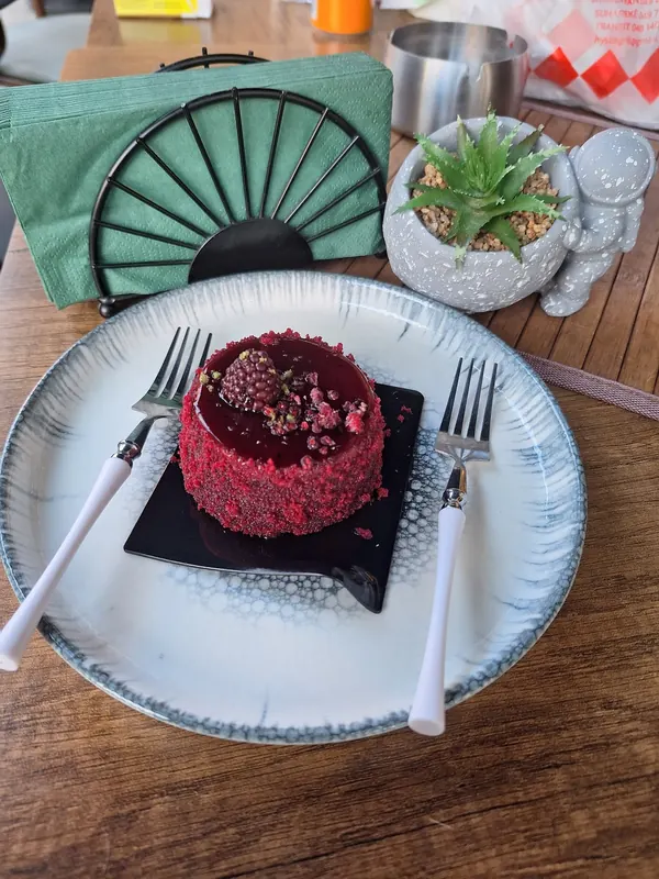 Red velvet dessert with a blackberry