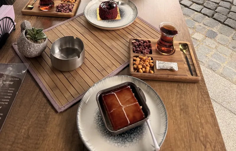 Tea, tres leches and red velvet cake on a terrace table